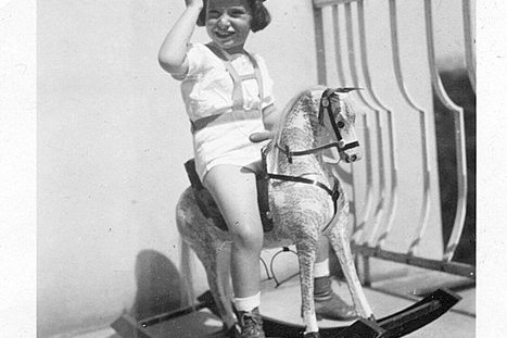 Ein junger Bub auf einem Schaukelpferd