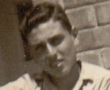 Ein Mann lehnt an einer Fassade